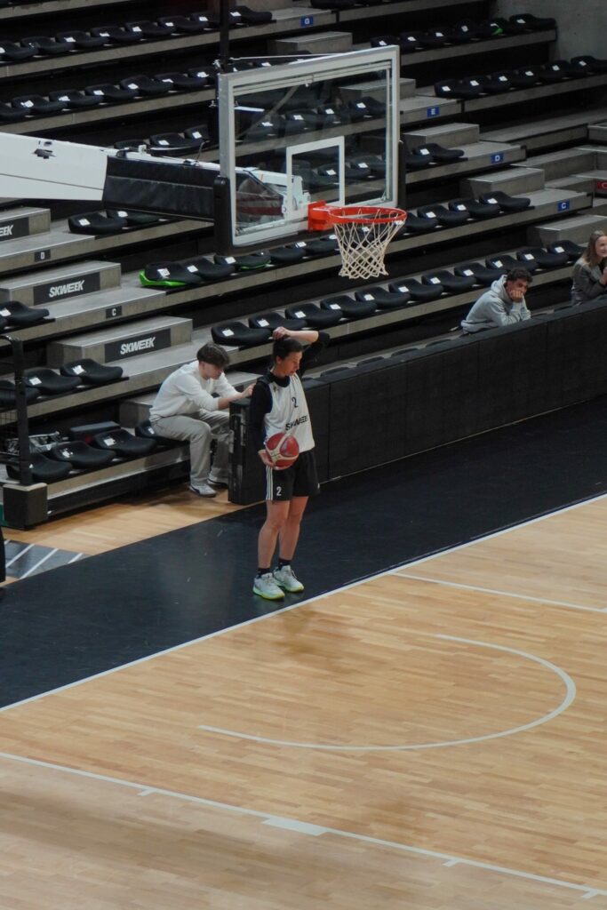 étudiant ISG prenant vidéos basketball féminin avec joueuse